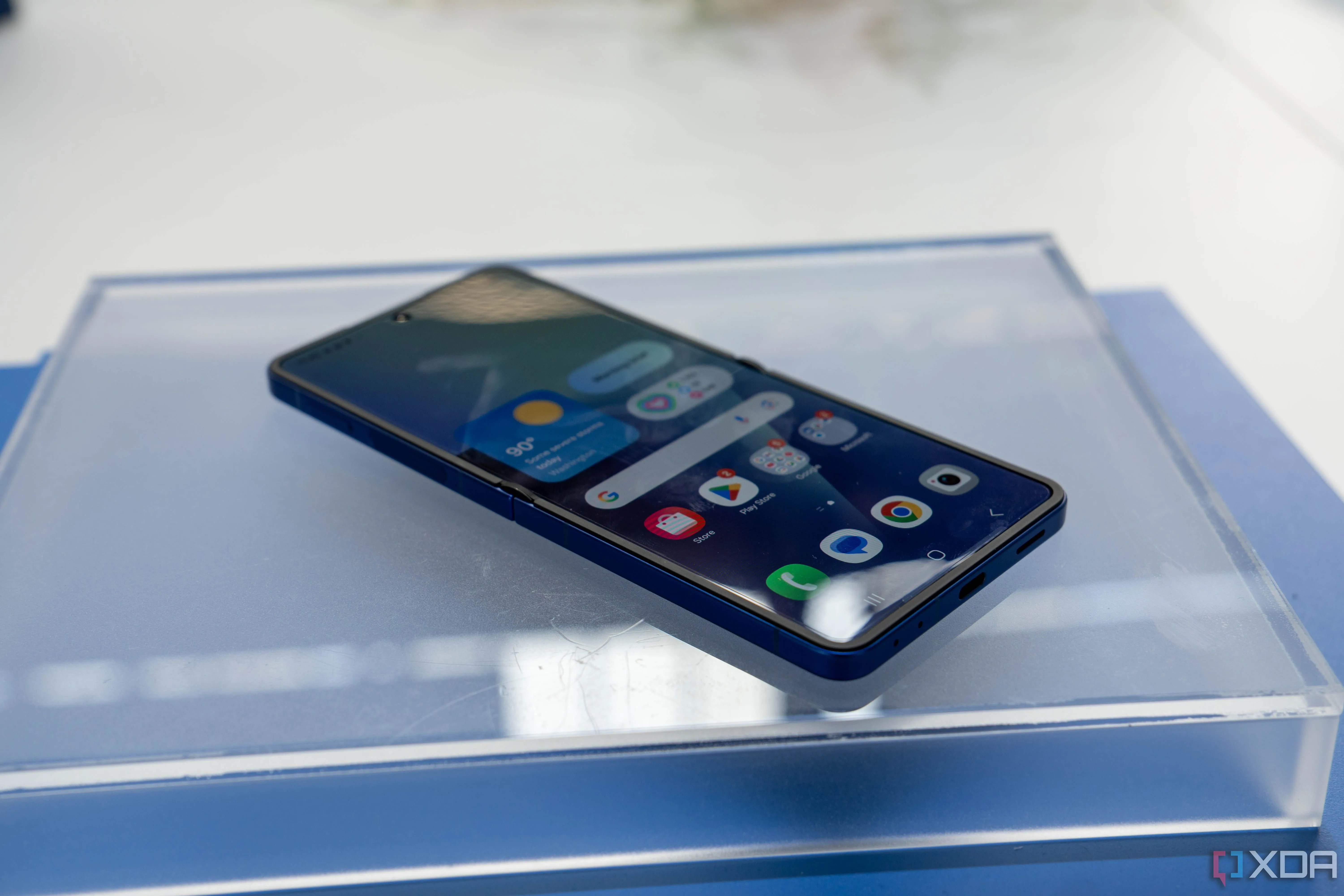 Điện thoại Samsung Galaxy Z Flip 7 mở ra trên mặt bàn, cho thấy màn hình chính và thiết kế tổng thể