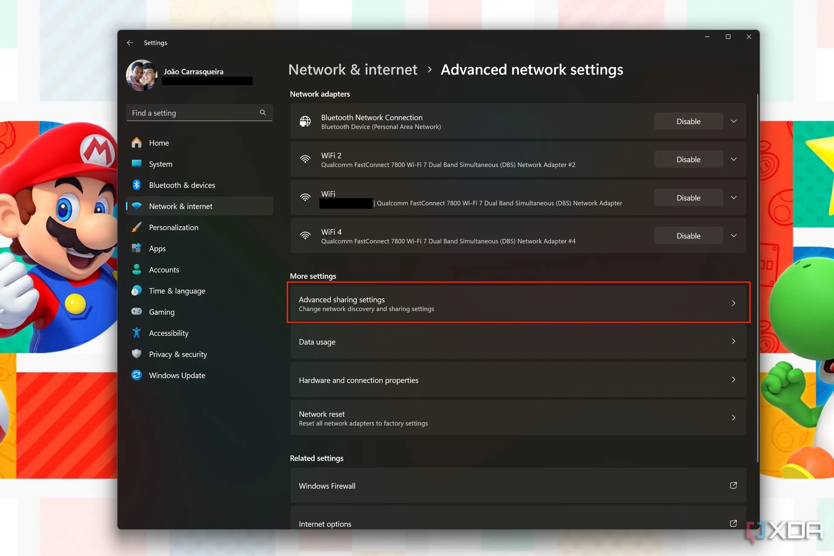 Màn hình cài đặt mạng nâng cao trên Windows 11, với nút &quot;Cài đặt chia sẻ nâng cao&quot; được tô sáng để quản lý chia sẻ