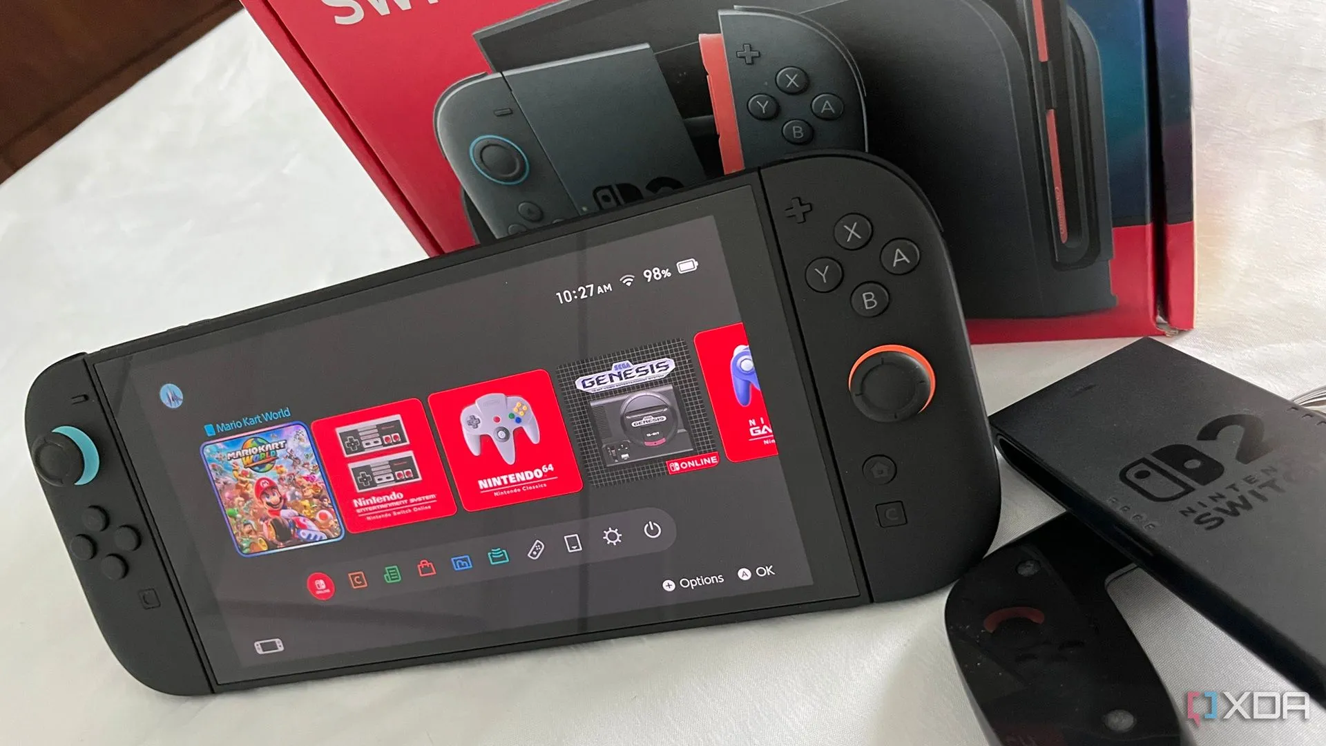 Máy chơi game Nintendo Switch 2 màu đen với màn hình sáng và hai tay cầm Joy-Con màu đỏ và xanh lam, tượng trưng cho thế hệ console mới sẵn sàng đón nhận các bộ sưu tập game retro.