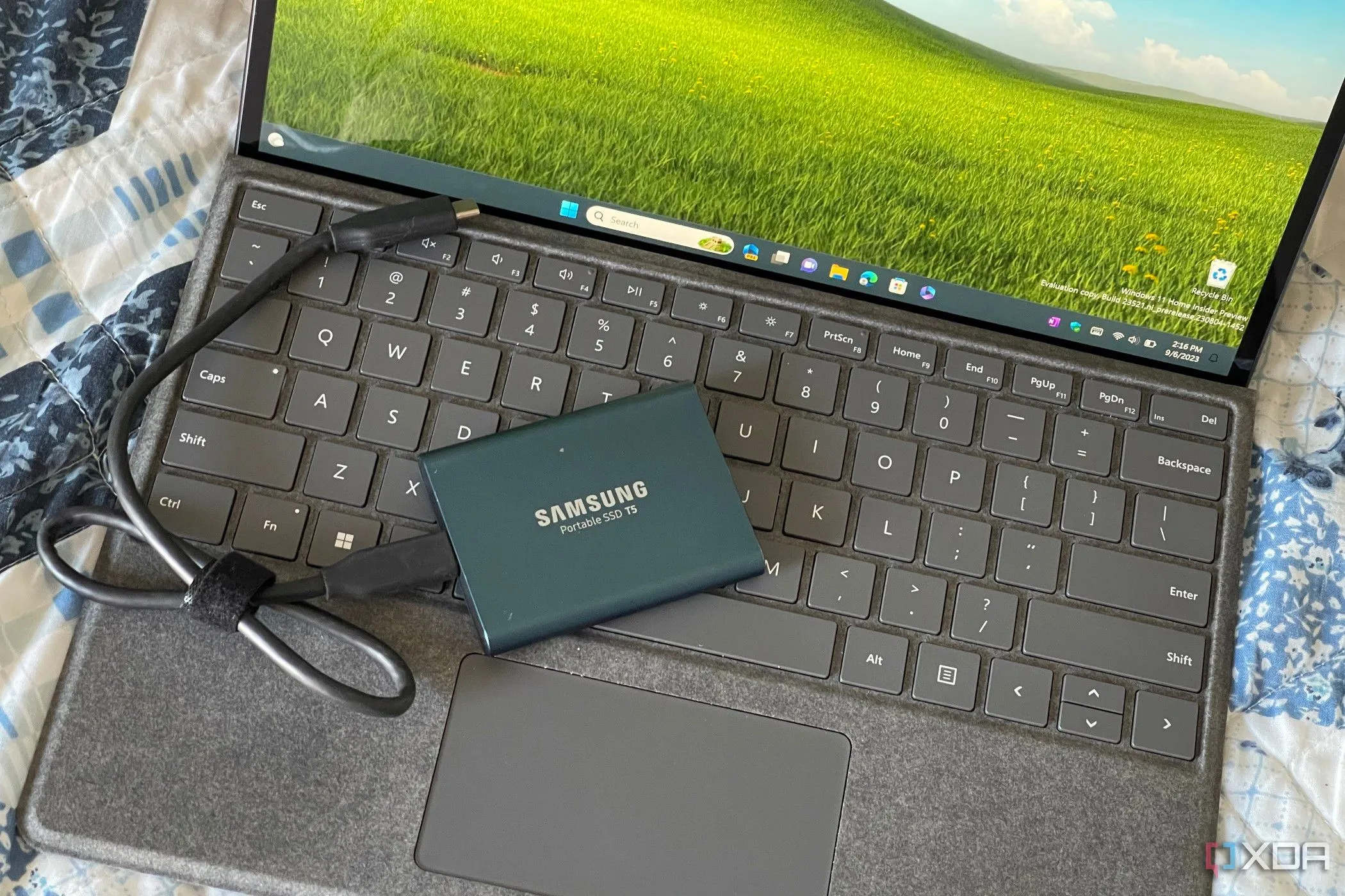 Máy tính Surface Pro 8 kết nối với ổ SSD ngoài, minh họa việc sao lưu và đồng bộ cài đặt trên Windows 11.