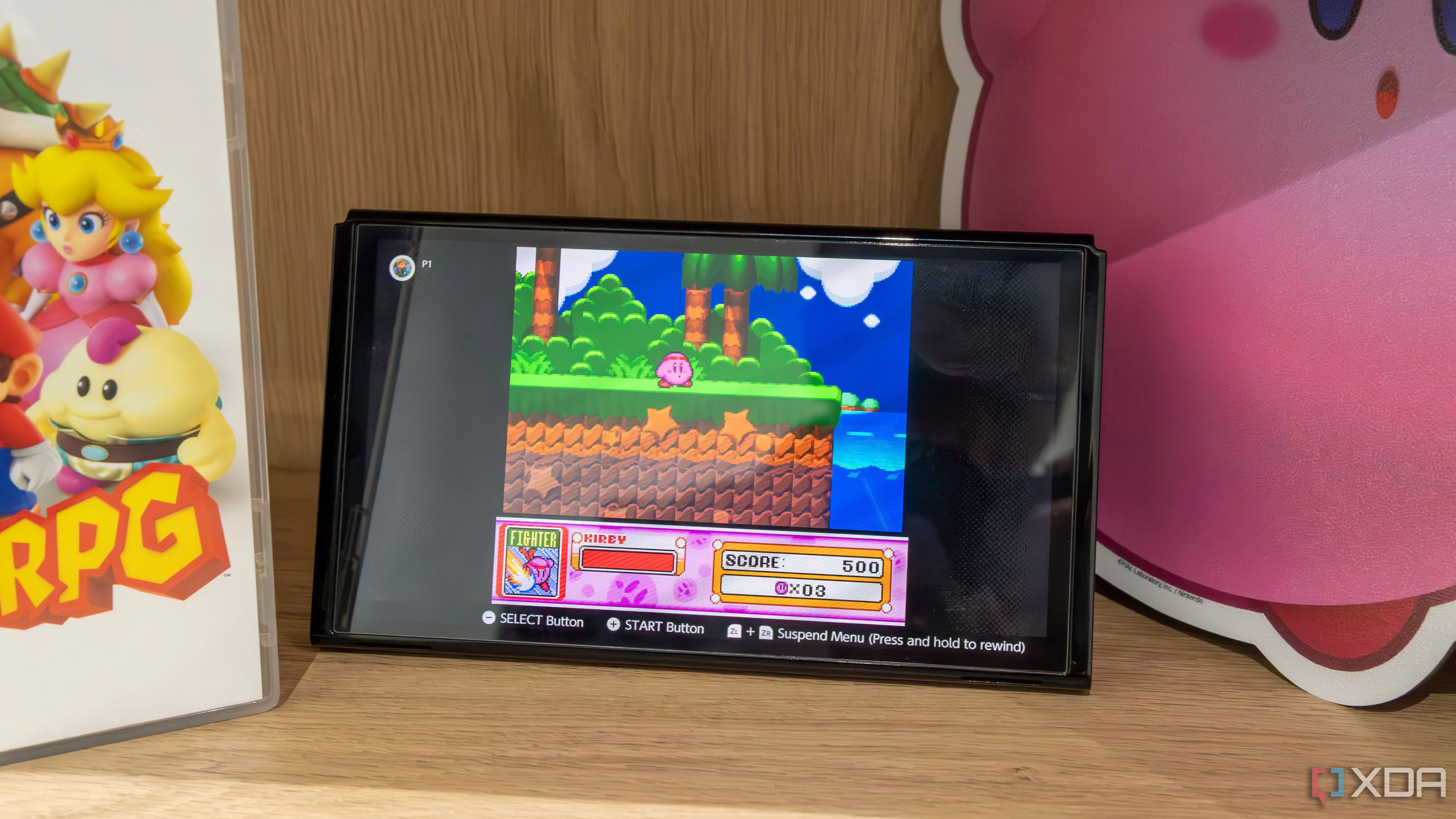 Một máy chơi game Nintendo Switch OLED với Joy-Con đã tháo rời đang chạy game Kirby Super Star trên ứng dụng SNES Switch Online, minh họa cho trải nghiệm chơi game thư giãn.